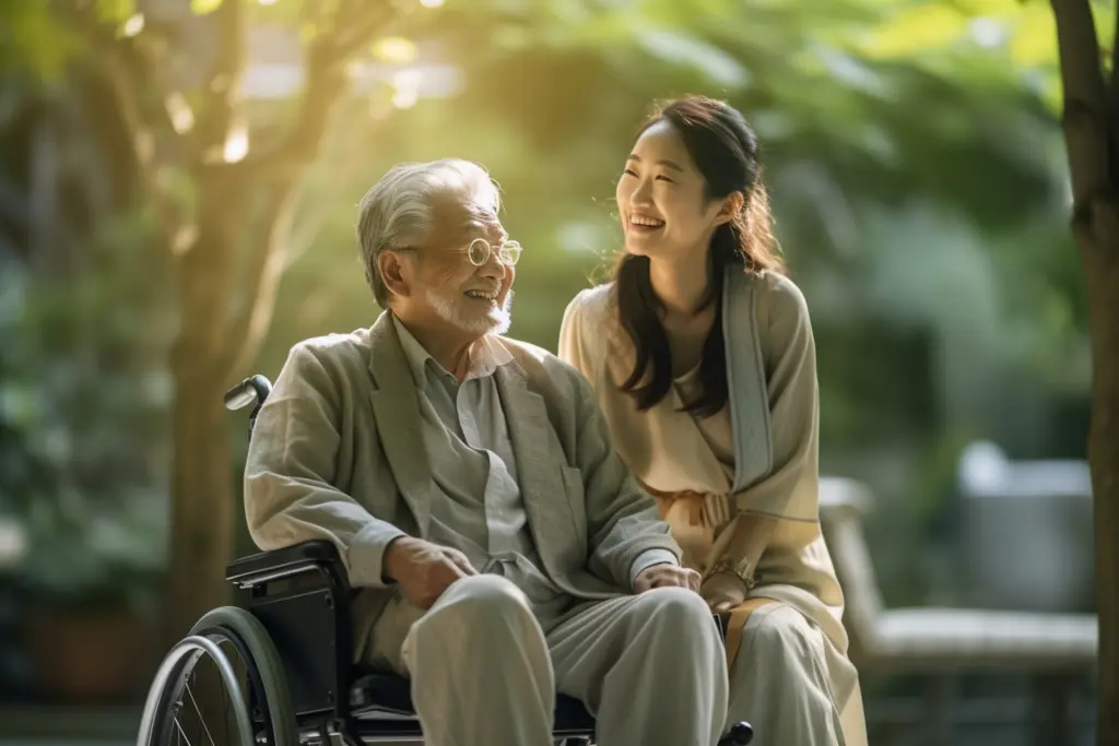 車椅子に座る男性と介助者