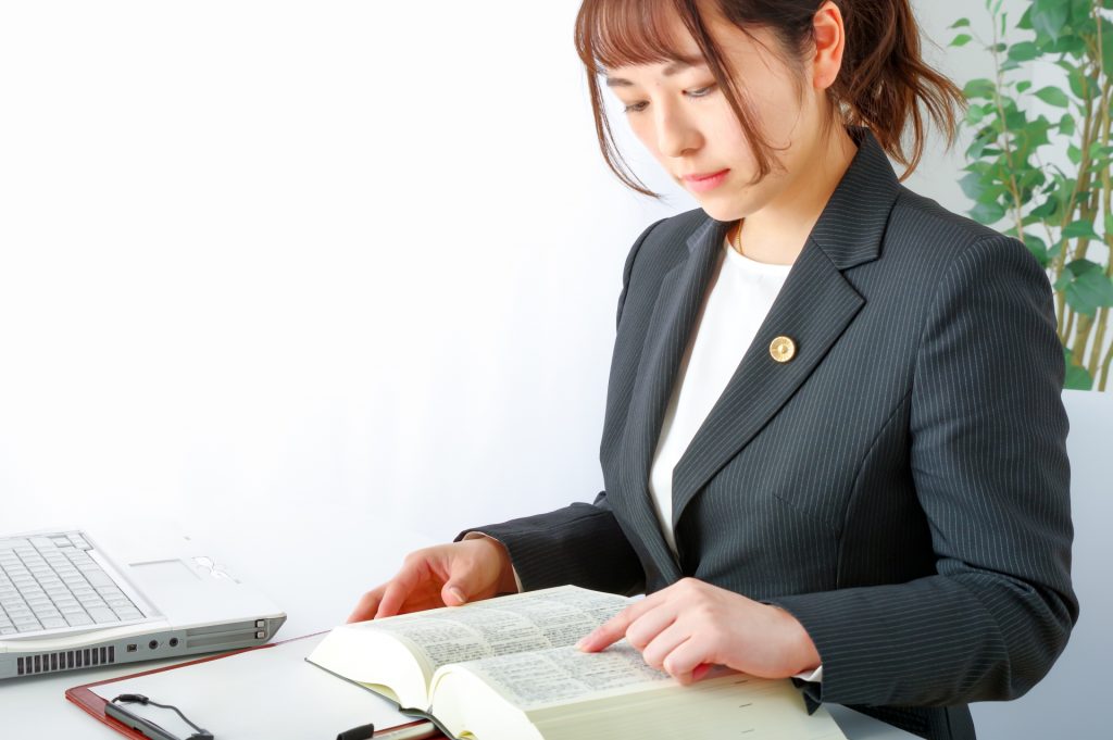 
法律書を読む女性弁護士