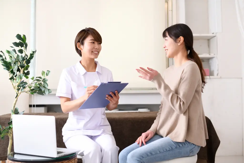 白衣の女性(医療従事者)とカウンセリング