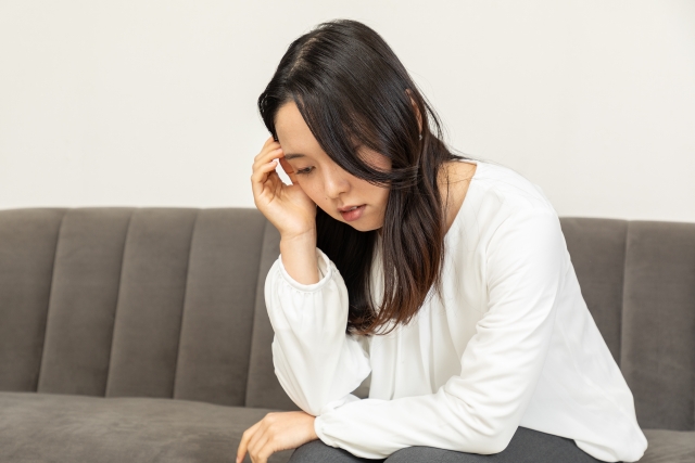 体調不良の女性