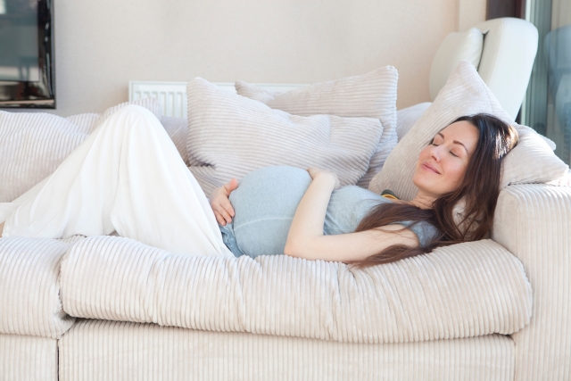 ソファーで横になる妊婦